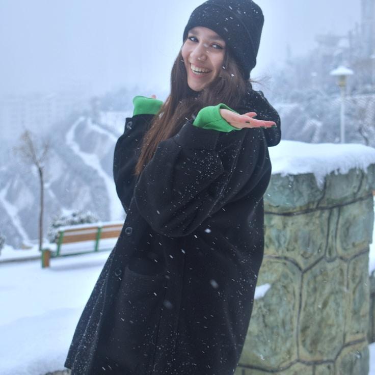 Avery Stone, Lead Design Curator at QuietGrowthFramework, reviewing corporate floral arrangements